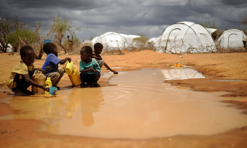 Somali boys collect water from a puddle at the sprawling Dadaab refugee complex in Kenya. Photograph: Tony Karumba/AFP/Getty