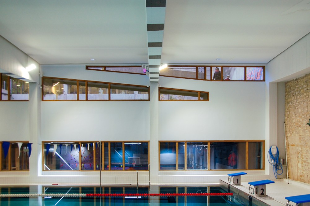 Schoolkinderen gluren binnen in het Piscine Saint-Merri in Parijs onderweg naar hun les.
